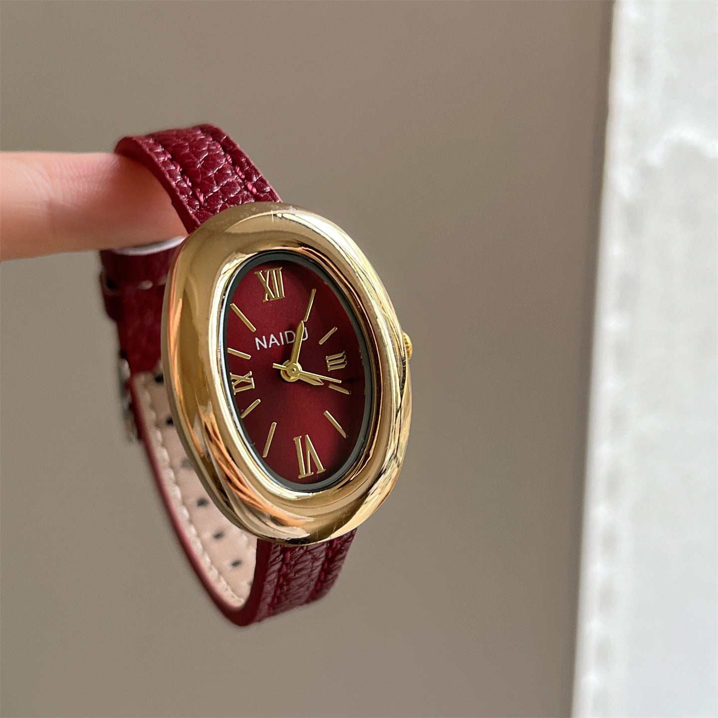 A lady with an oval-shaped small gold watch