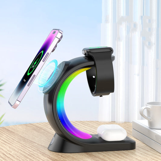 4-in-1 RGB magnetic wireless charger with smartphone, watch, and wireless earbuds on a wooden surface. Global swanky 7
