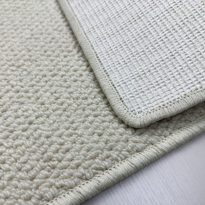A balcony with a faux sisal off-white carpet