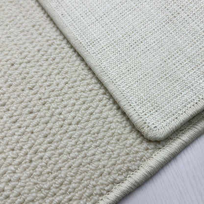 A balcony with a faux sisal off-white carpet