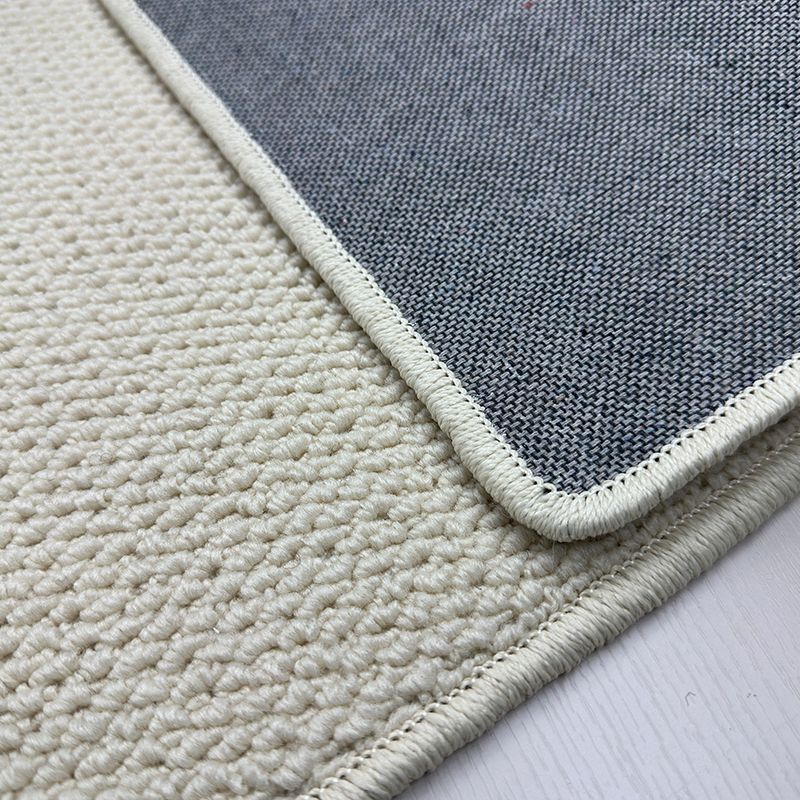 A balcony with a faux sisal off-white carpet