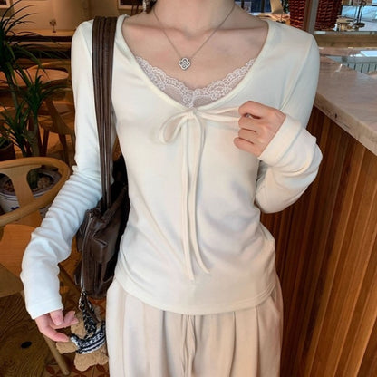 A beige lace V-neck top paired