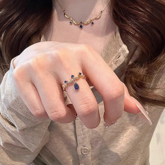 A blue teardrop ring with ancient glass craftsmanship and lace