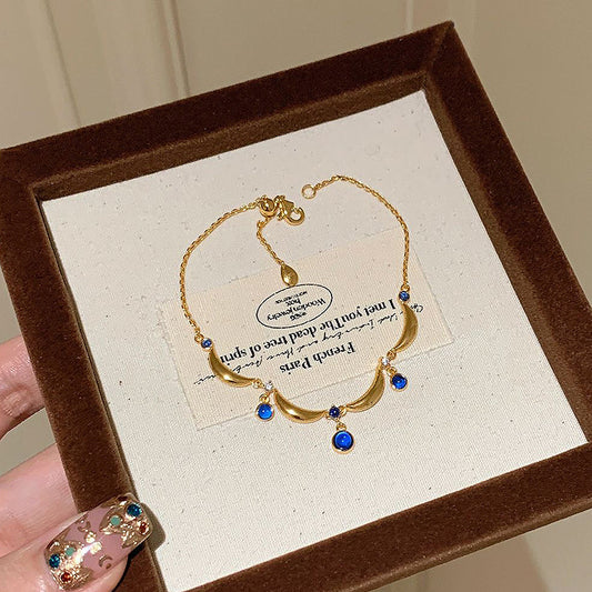 A blue teardrop ring with ancient glass craftsmanship and lace