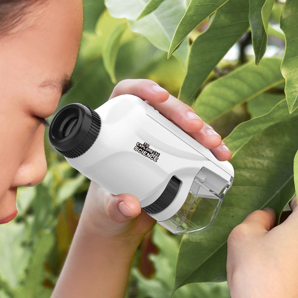 A child holding a microscope