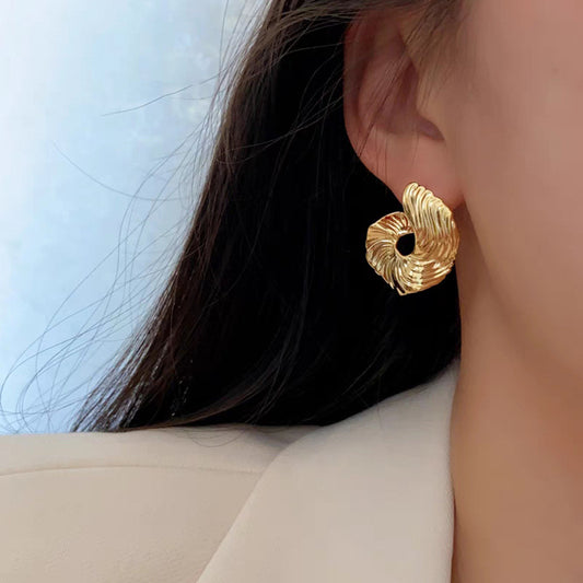 A girl with a unique and distinctive design of ear studs