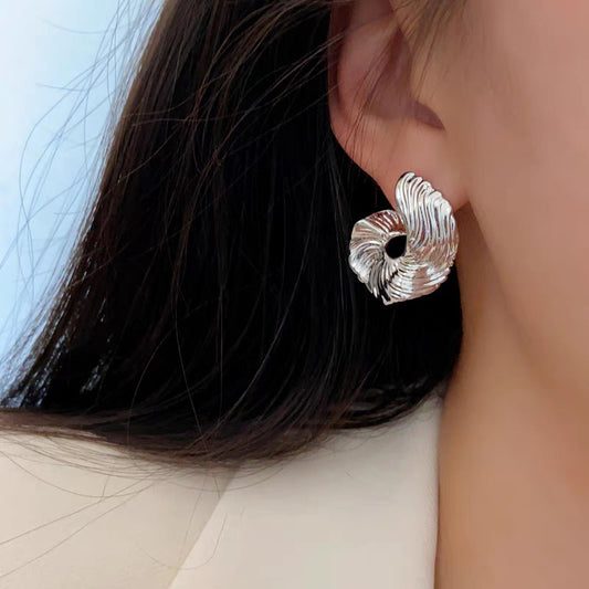 A girl with a unique and distinctive design of ear studs