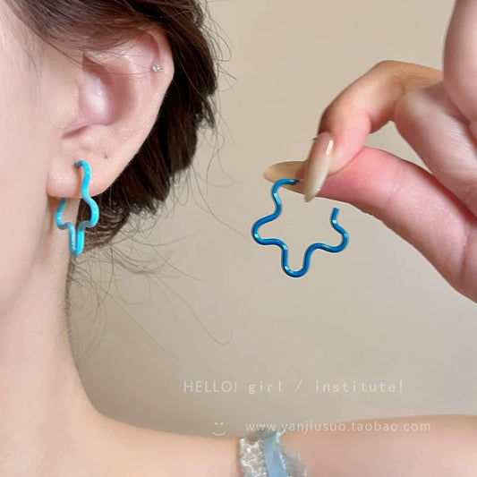 A girl with super fairy-like colorful flower earrings