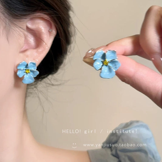 A girl with super fairy-like colorful flower earrings