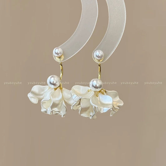 A girl with super fairy-like colorful flower earrings