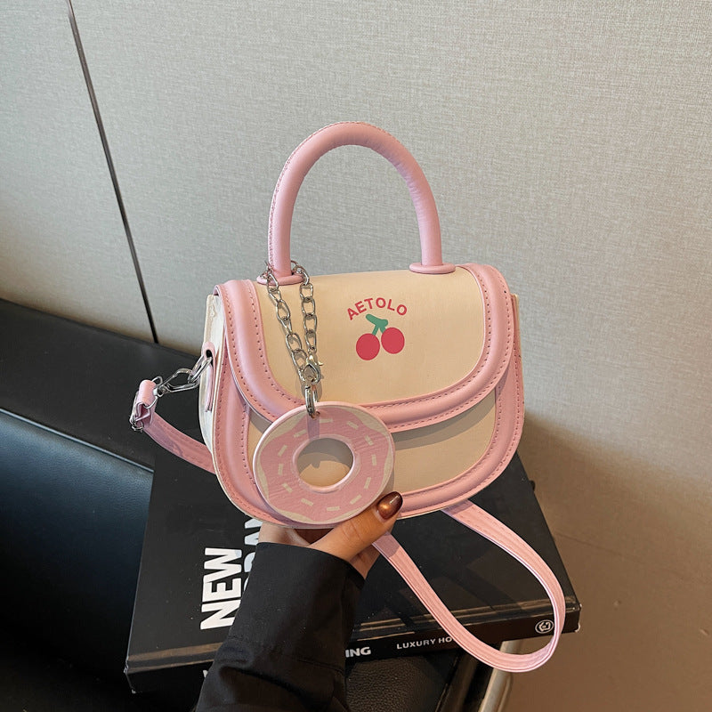 A hand-held bag with a crossbody saddle