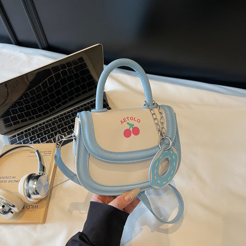A hand-held bag with a crossbody saddle