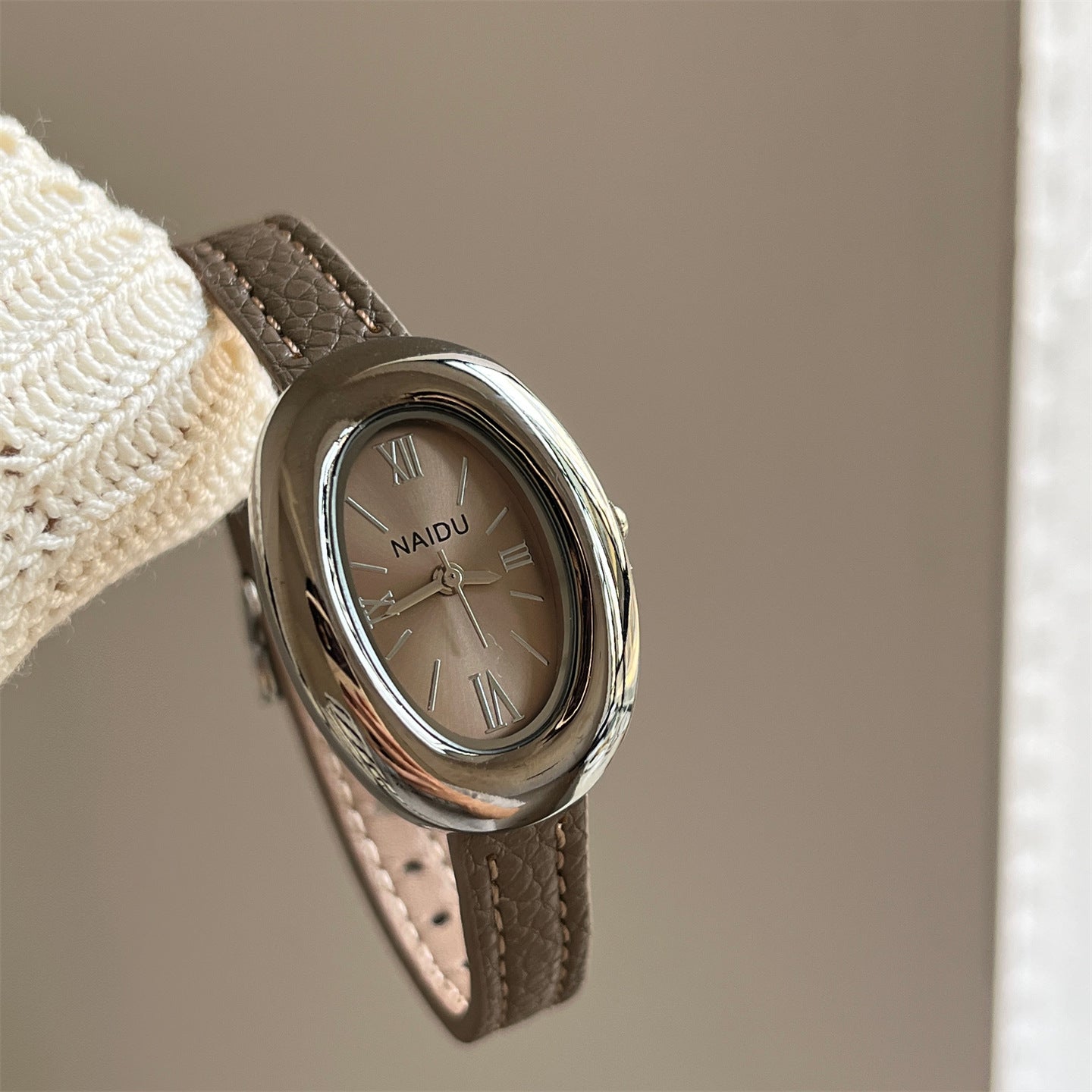 A lady with an oval-shaped small gold watch