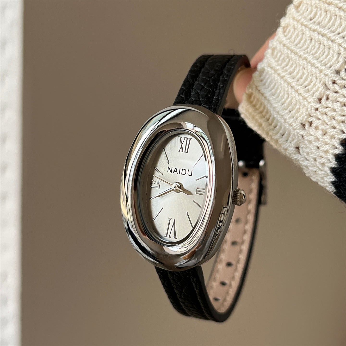 A lady with an oval-shaped small gold watch