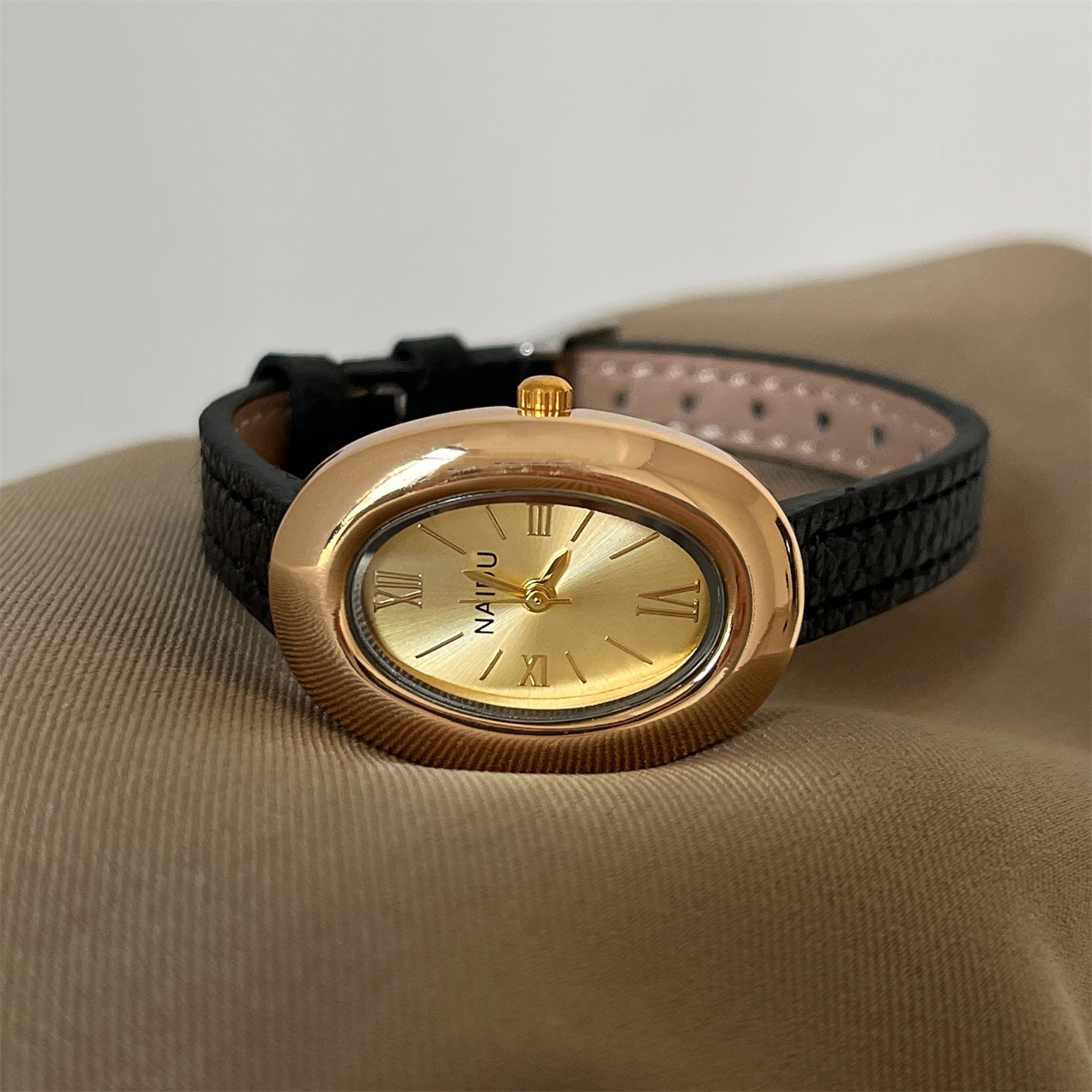 A lady with an oval-shaped small gold watch
