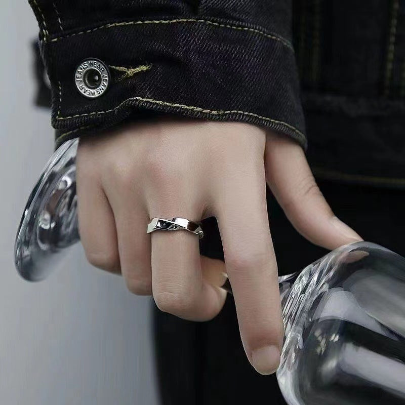 A man wearing a Mobius strip ring