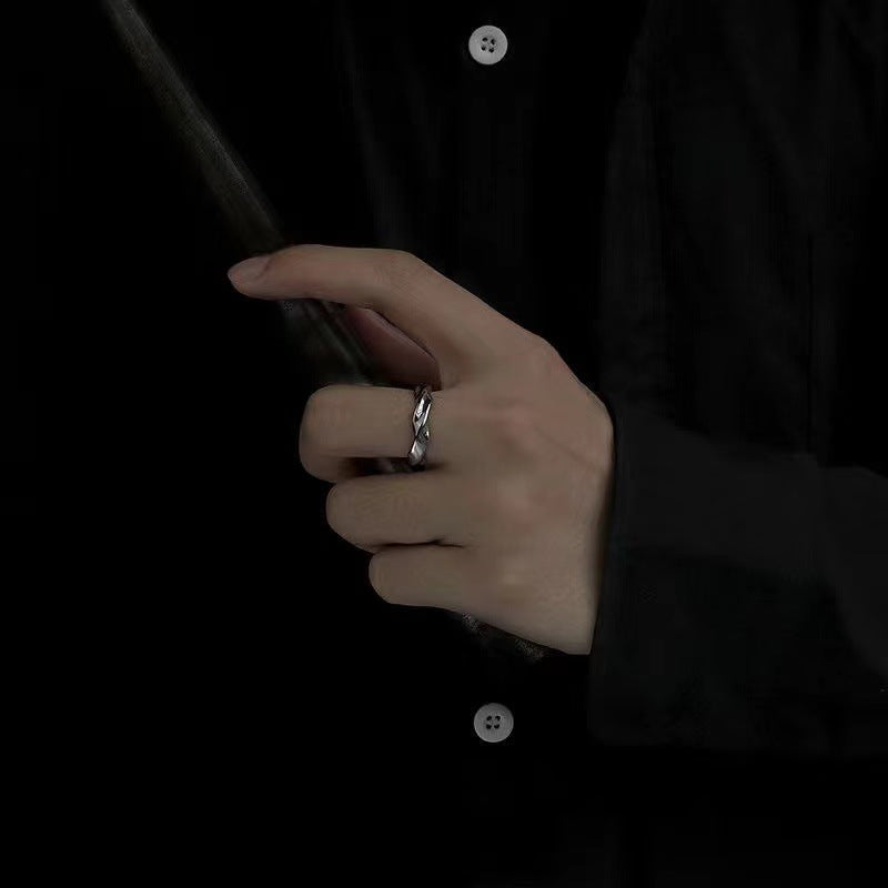 A man wearing a Mobius strip ring