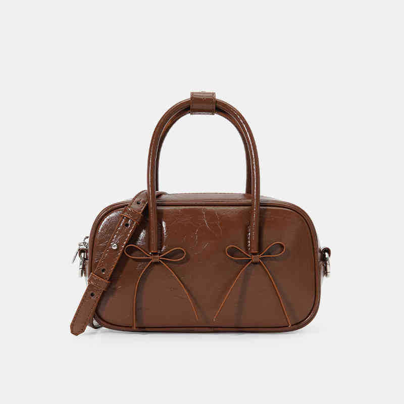 A red female baguette bag with a bow