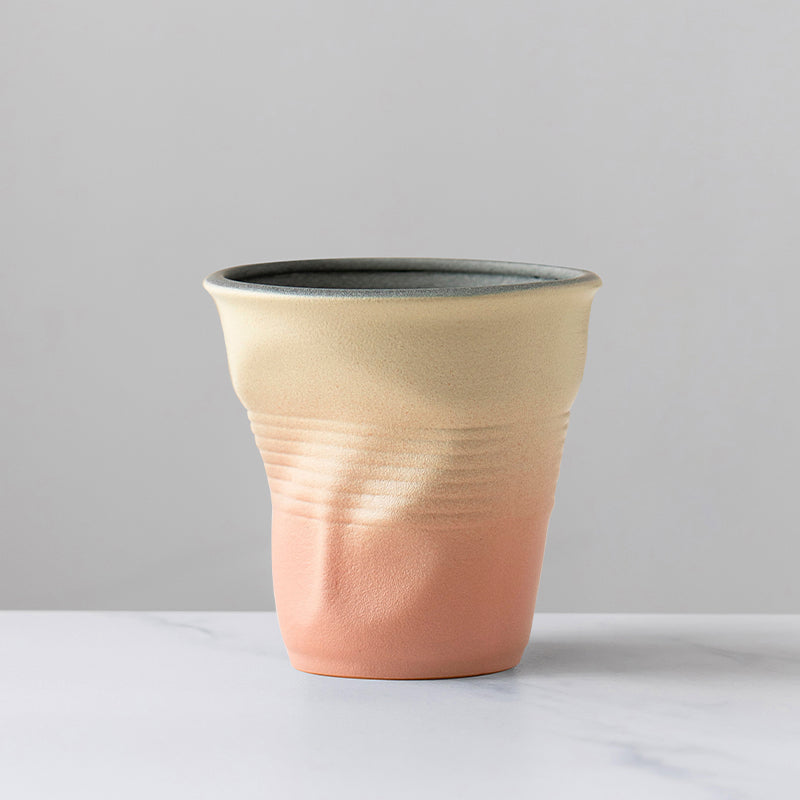 A rough pottery hand-molded pleated cup