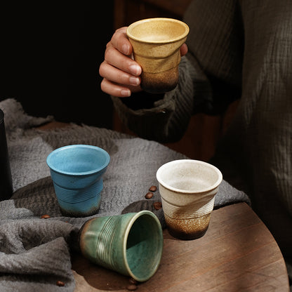 A rough pottery hand-molded pleated cup