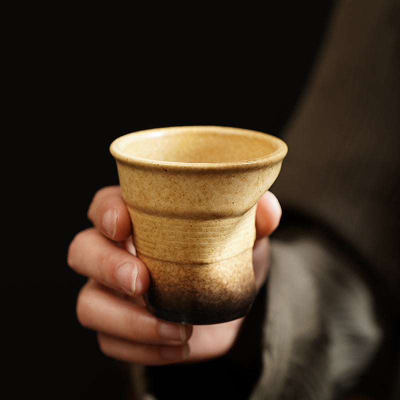 A rough pottery hand-molded pleated cup
