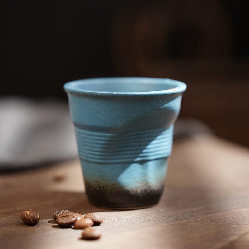 A rough pottery hand-molded pleated cup