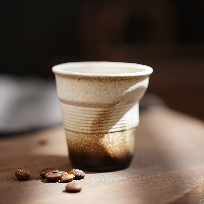 A rough pottery hand-molded pleated cup