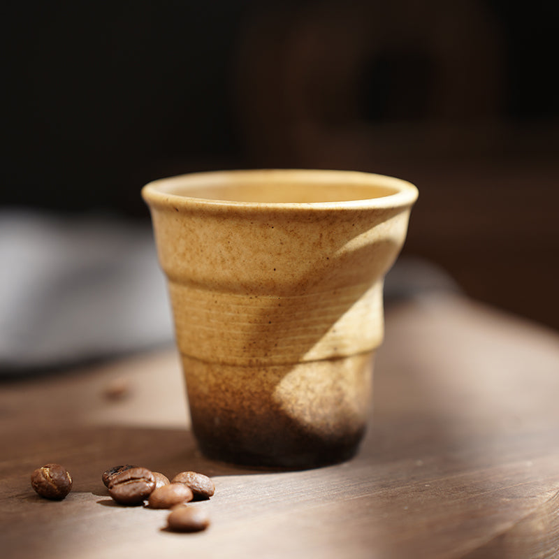 A rough pottery hand-molded pleated cup