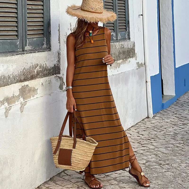 A sleeveless, high-waisted, form-fitting, low-necked long dress