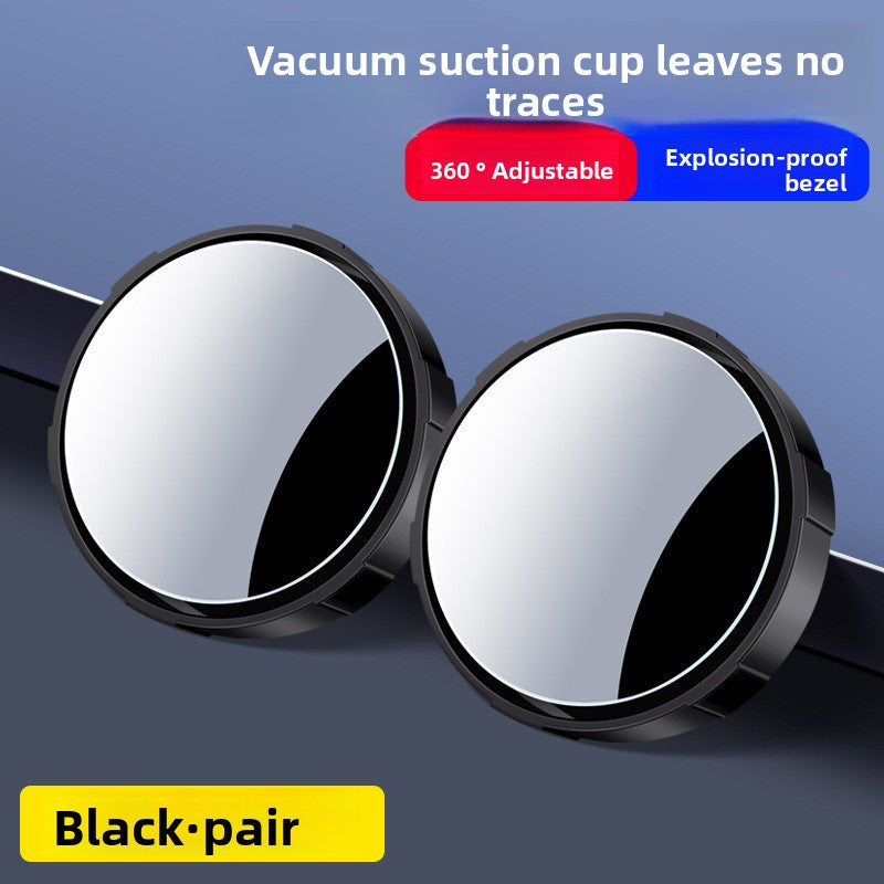 A small round car rearview mirror with a suction cup
