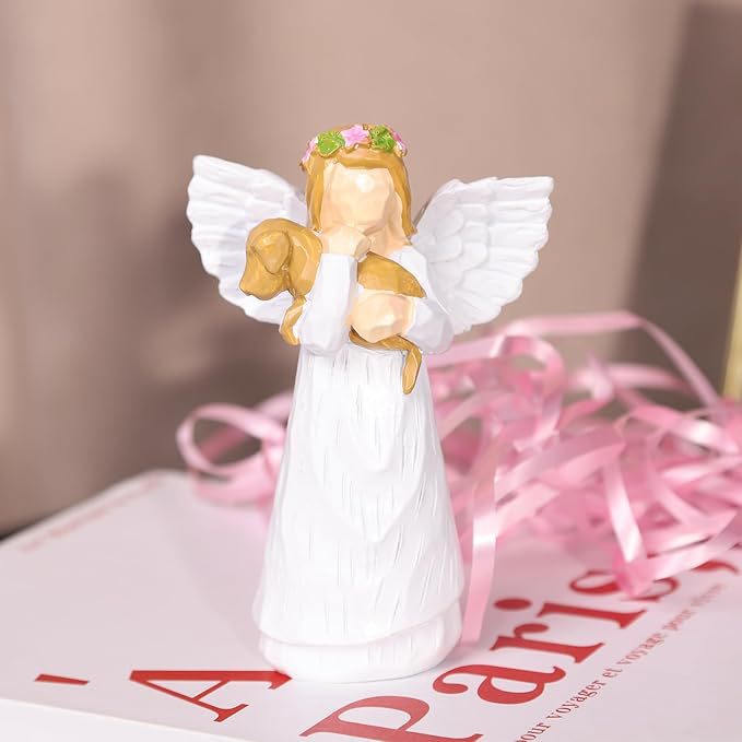 A souvenir table ornament of the Angel holding a dog