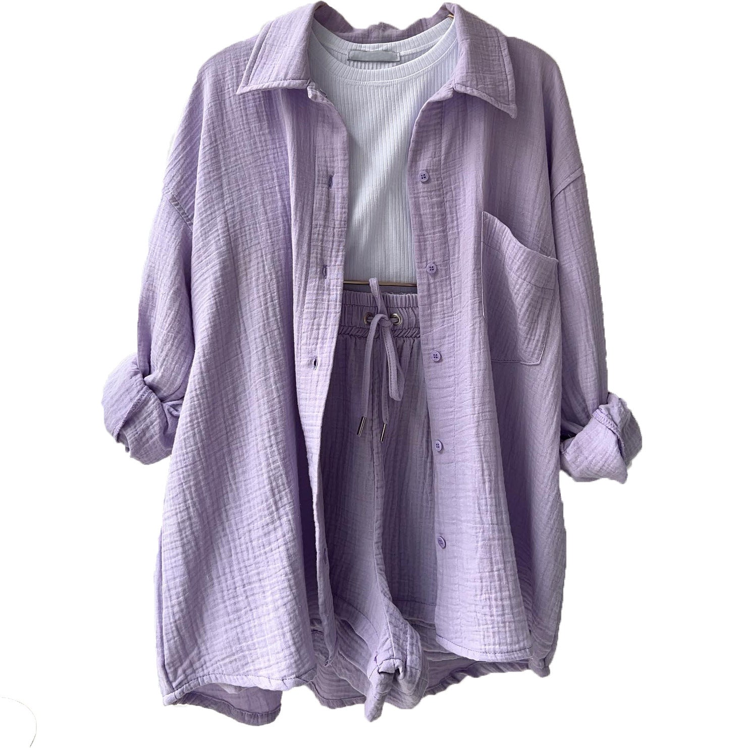 A two-piece set of wrinkled fabric shirt and high-waisted shorts