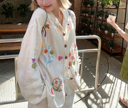 A white embroidered cotton and linen shirt