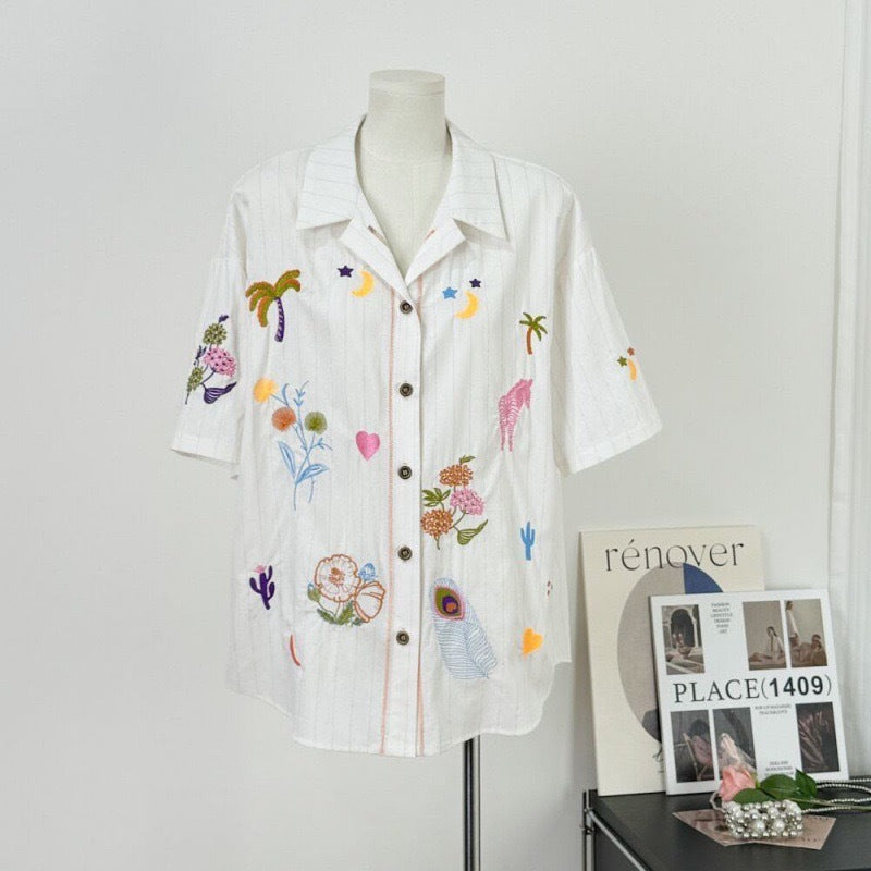 A white embroidered cotton and linen shirt
