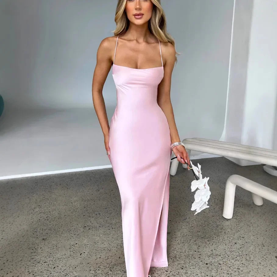 A woman in a sleeveless satin halter dress