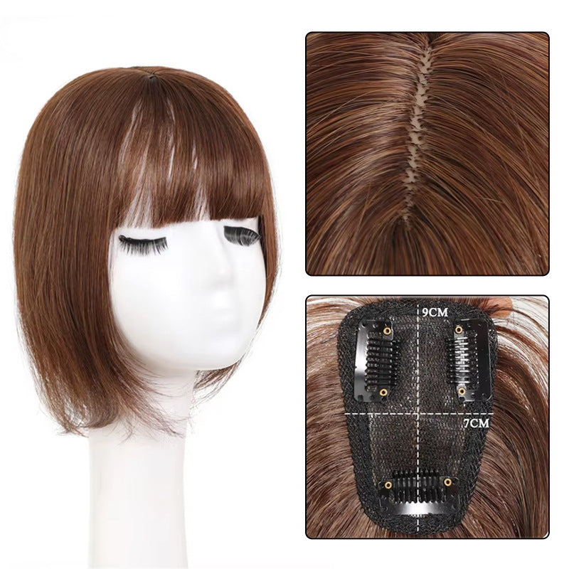 A woman wearing a faux hairpiece