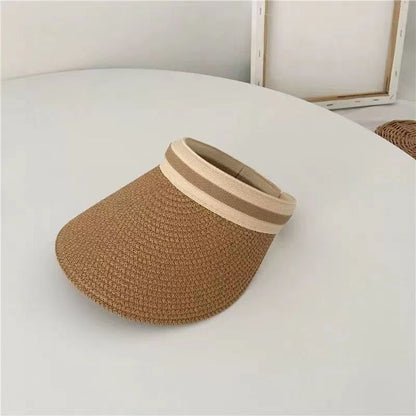 A woman wearing a straw sun hat in summer
