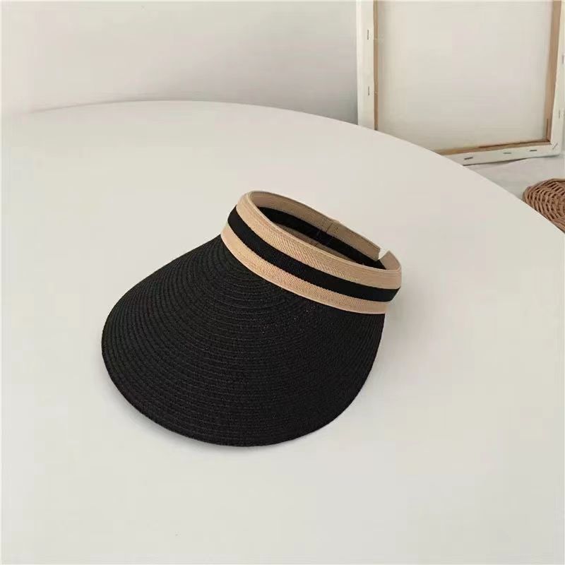A woman wearing a straw sun hat in summer