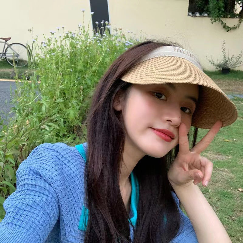 A woman wearing a straw sun hat in summer