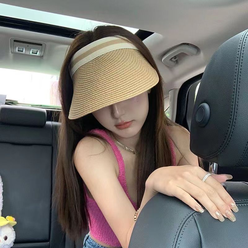 A woman wearing a straw sun hat in summer