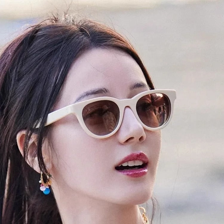 A woman wearing cat-eye sunglasses