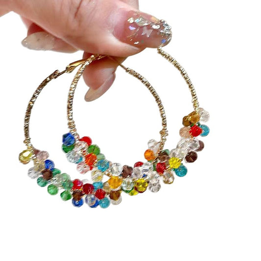 A woman with dazzling pearls wrapped around her ear loops