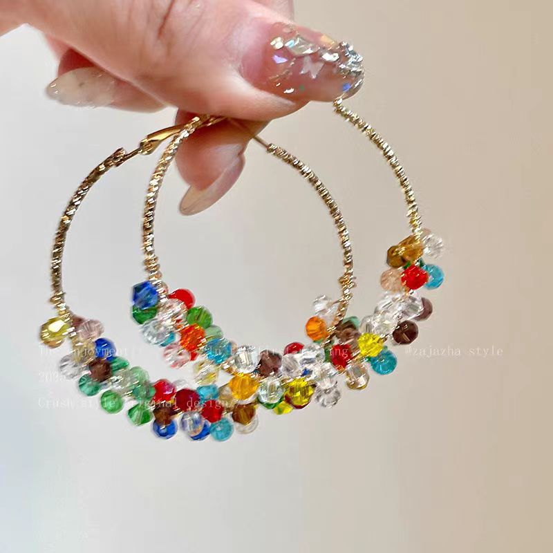 A woman with dazzling pearls wrapped around her ear loops
