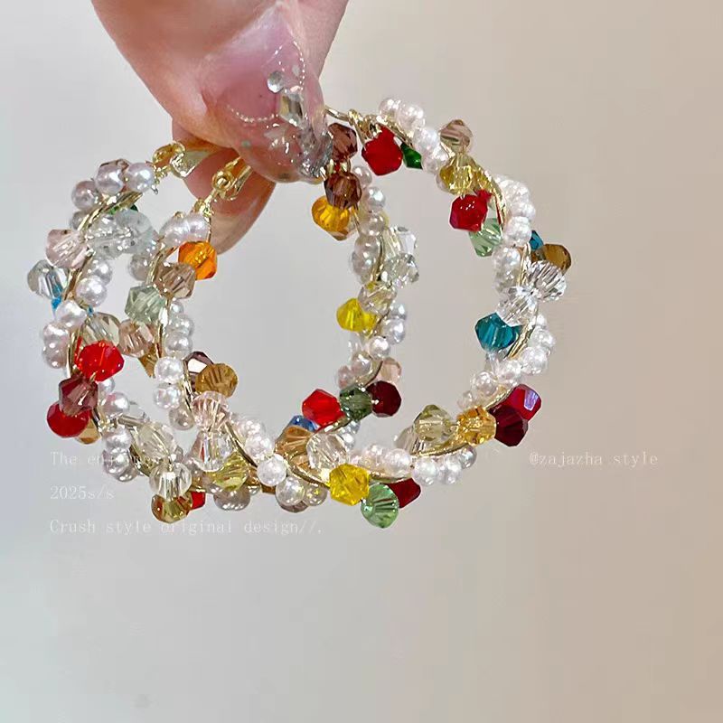 A woman with dazzling pearls wrapped around her ear loops