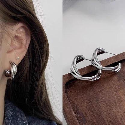 A woman with plain hoop earrings