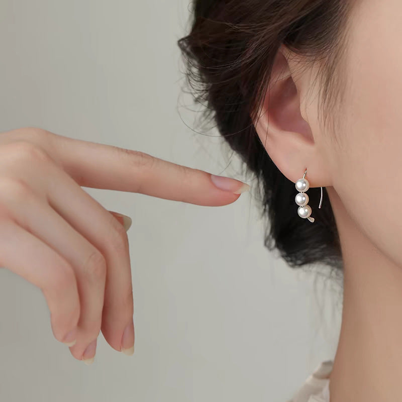 A woman with plain hoop earrings