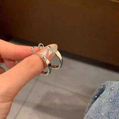 A woman with plain hoop earrings