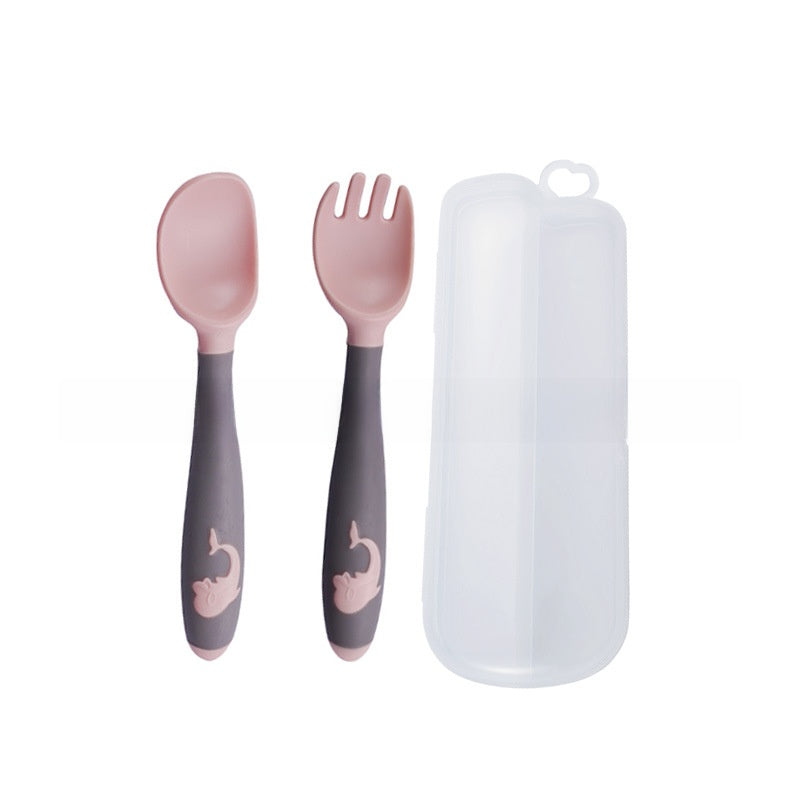 Baby learning to eat spoon and fork