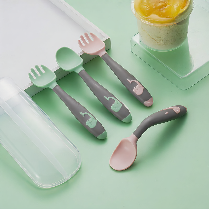Baby learning to eat spoon and fork