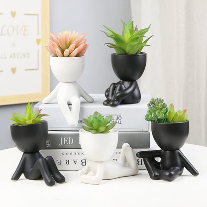 Black lazy person's small potted plant